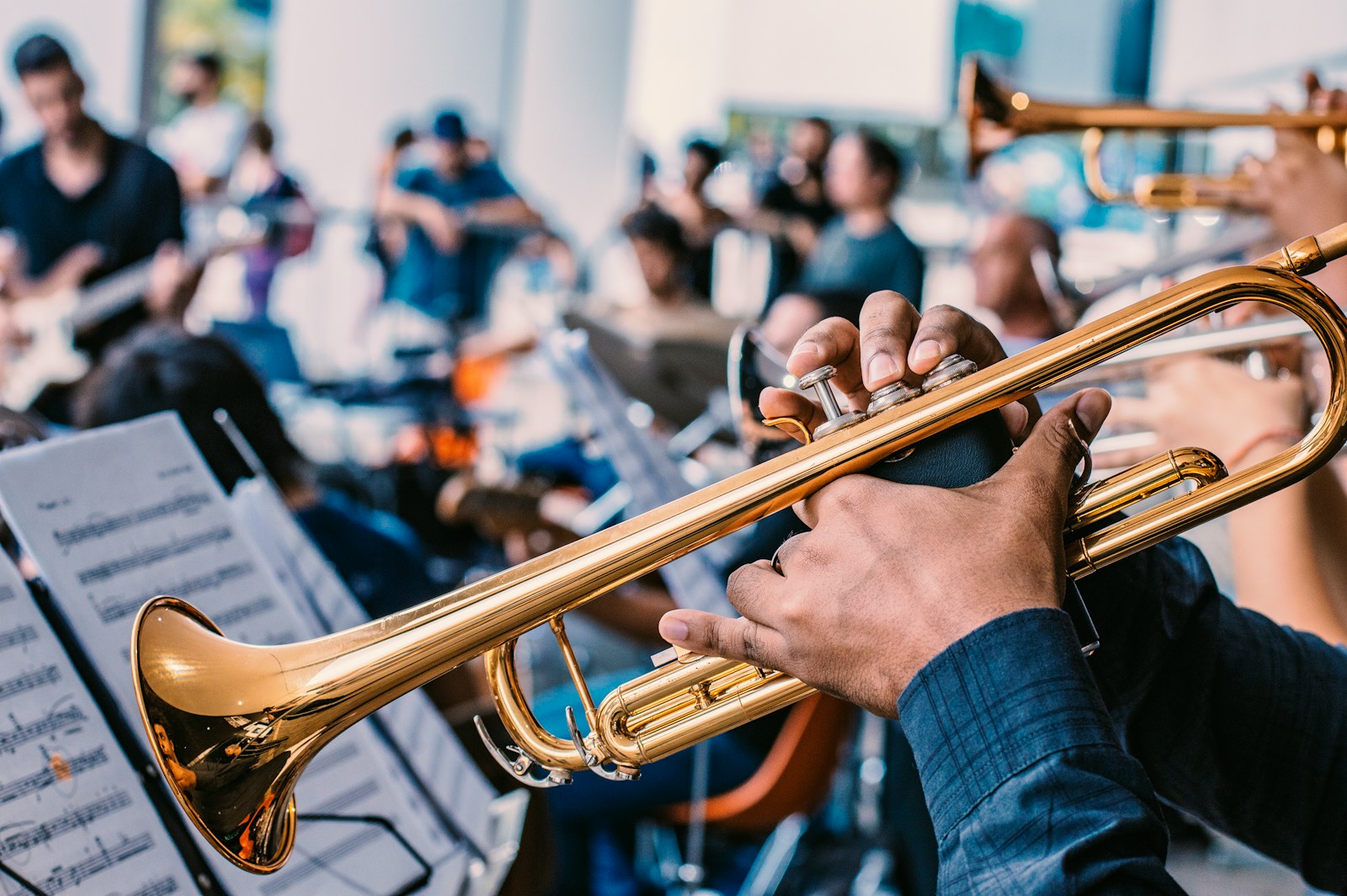 person playing gold trumpet